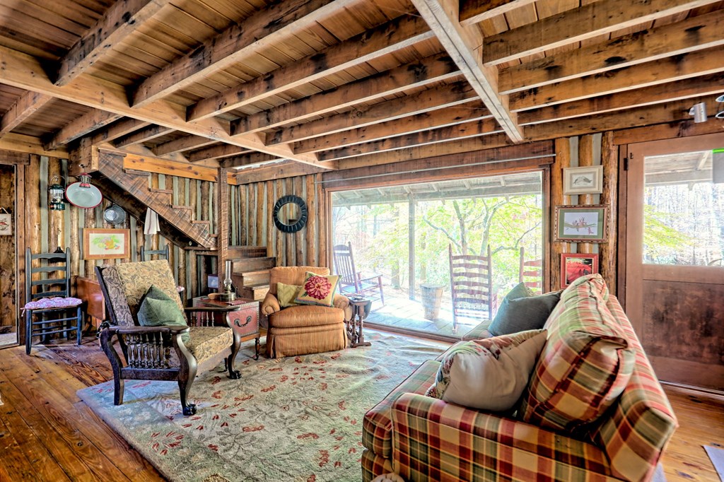 1307 Clear Creek Road Hayesville, NC 28904 - Photo 16 of 65 a living room with furniture and a large window