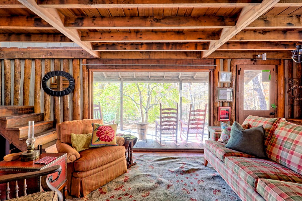 1307 Clear Creek Road Hayesville, NC 28904 - Photo 17 of 65 a living room with furniture and a window