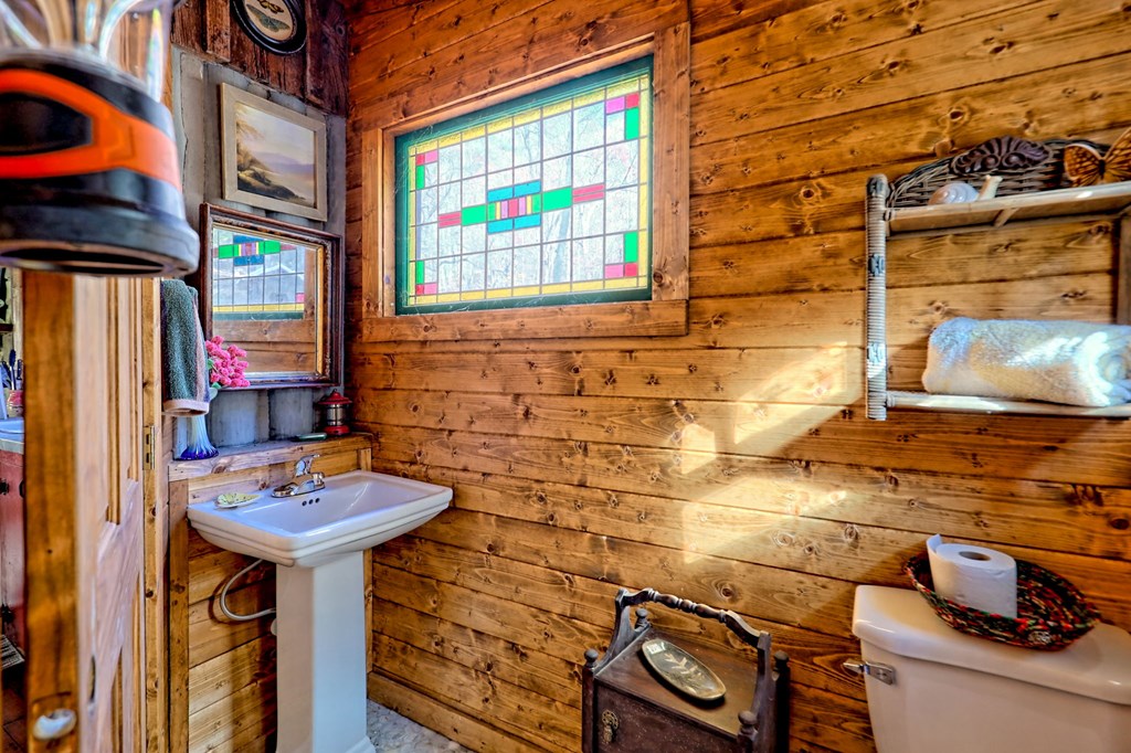 1307 Clear Creek Road Hayesville, NC 28904 - Photo 23 of 65 a bathroom with a sink and a mirror