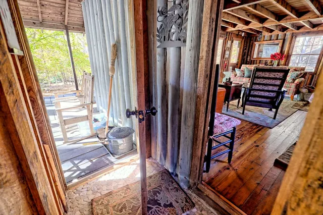 a front view of a house with wooden floor and furniture