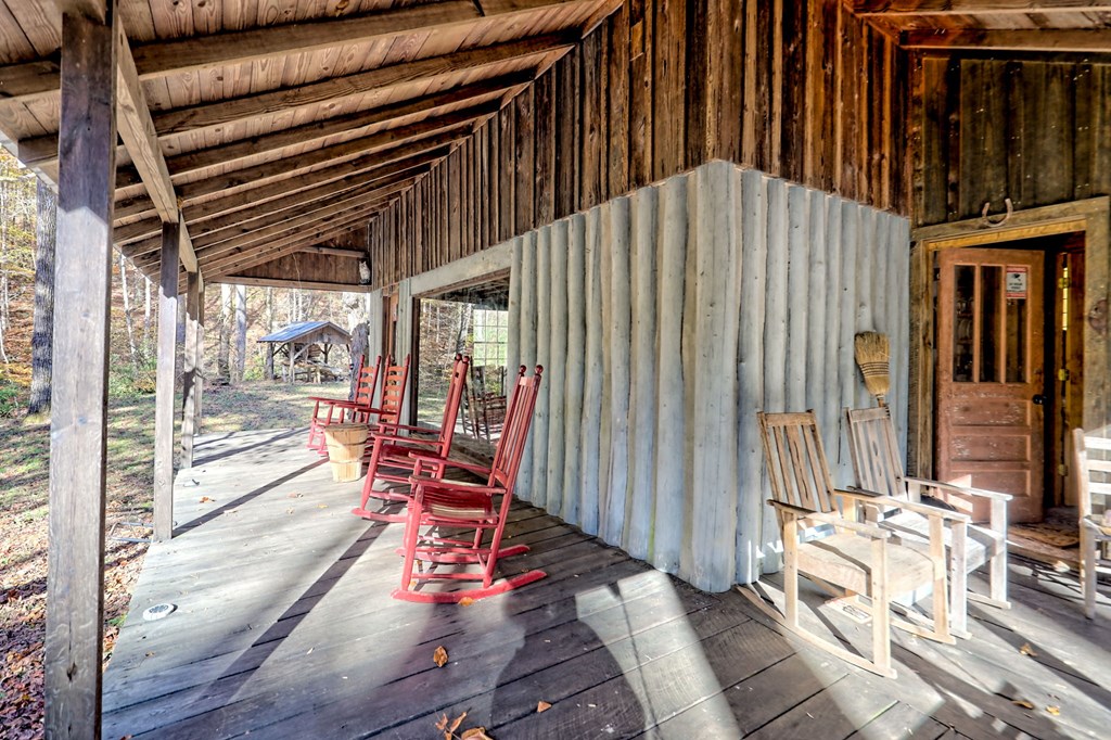 1307 Clear Creek Road Hayesville, NC 28904 - Photo 27 of 65 a view of a patio with table and chairs wooden floor and fence
