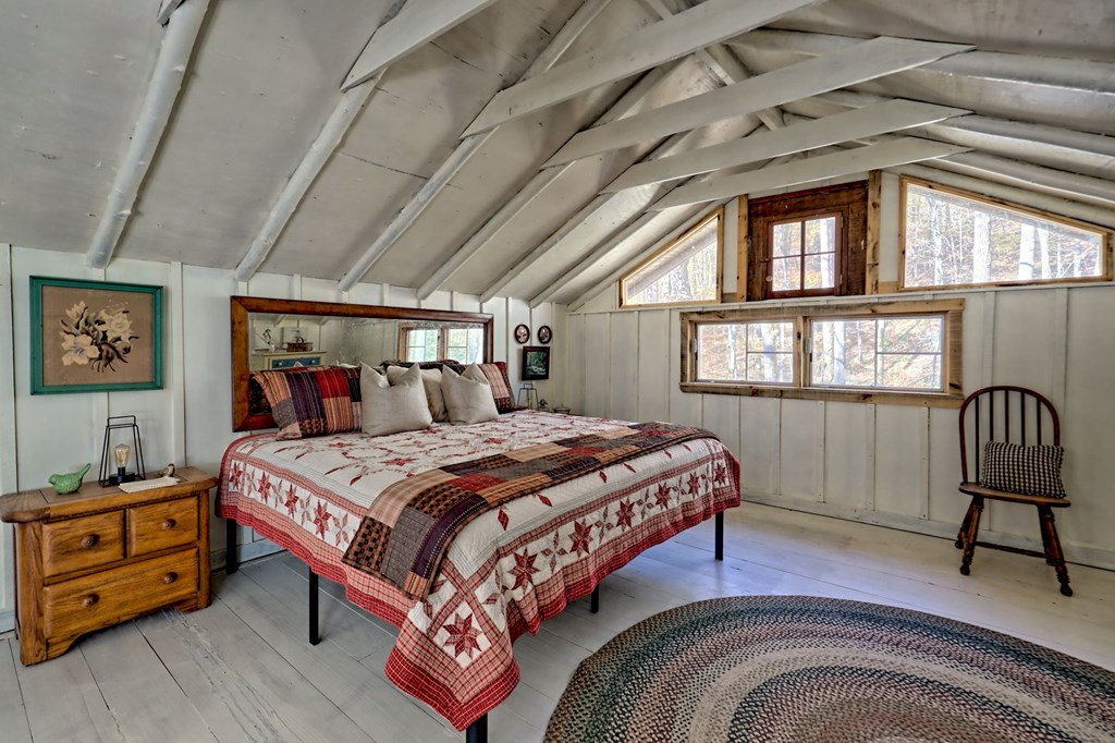 1307 Clear Creek Road Hayesville, NC 28904 - Photo 31 of 65 a bedroom with a bed and a window