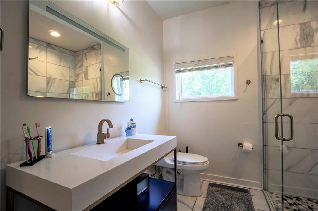 811 King Road Stone Mountain, GA 30088 - Photo 12 of 19 a bathroom with a sink a toilet and shower