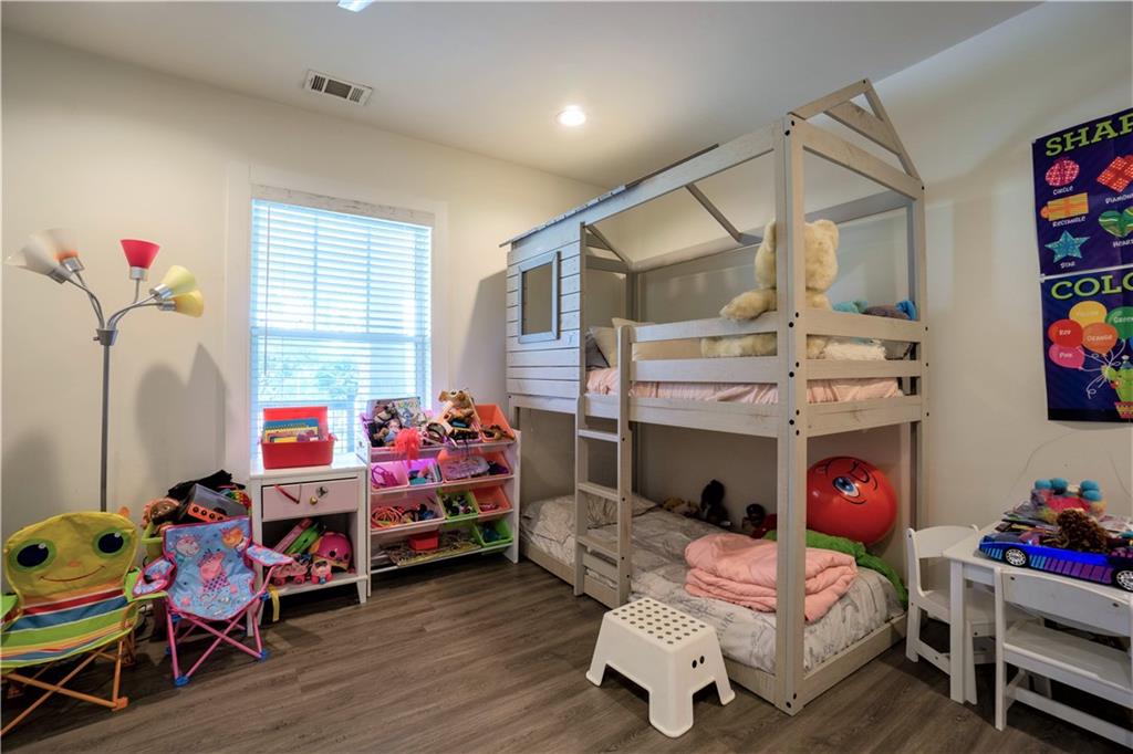 811 King Road Stone Mountain, GA 30088 - Photo 15 of 19 a bedroom with a bed and wooden floor