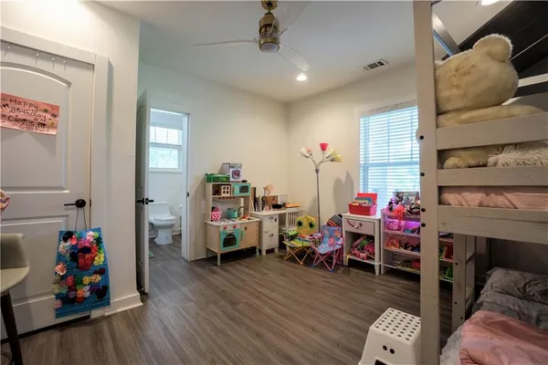 a bed room with a bed and a chair