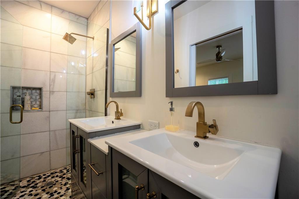 811 King Road Stone Mountain, GA 30088 - Photo 18 of 19 a bathroom with a double vanity sink and mirror
