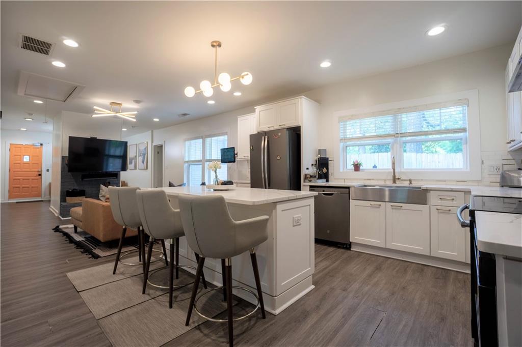 811 King Road Stone Mountain, GA 30088 - Photo 10 of 19 a kitchen with stainless steel appliances kitchen island granite countertop a table chairs sink and microwave