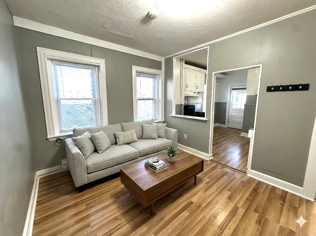 1076 Washington Street, Unit 3 Norwood, MA 02062 - Photo 6 of 8 a living room with furniture and wooden floor