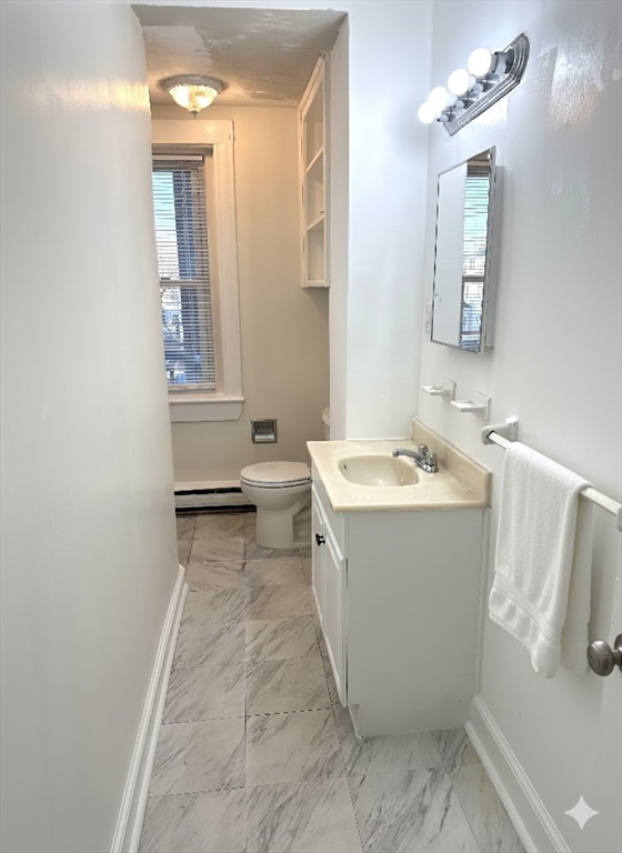 1076 Washington Street, Unit 3 Norwood, MA 02062 - Photo 8 of 8 a bathroom with a sink toilet and shower