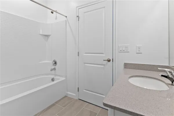 a view of an empty room with closet and a window