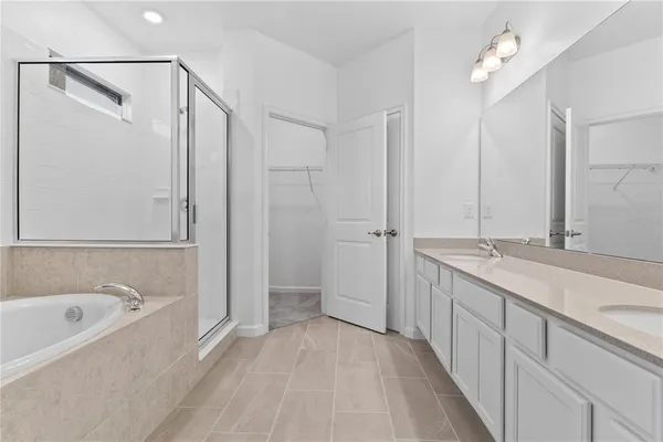 a bathroom with a double vanity sink and mirror