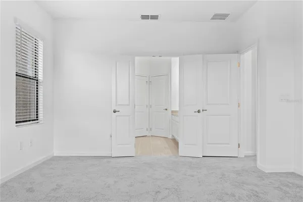 a view of a house with swimming pool and sitting area