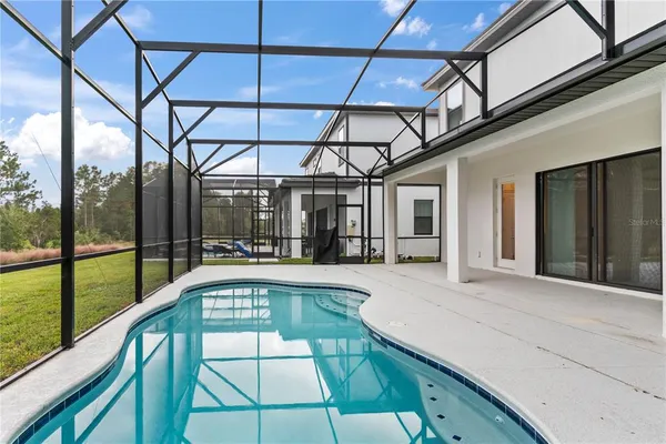 a living room with furniture and floor to ceiling windows