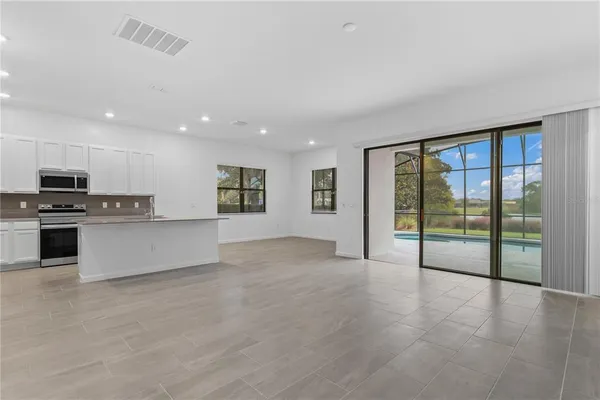 a large kitchen with cabinets and stainless steel appliances