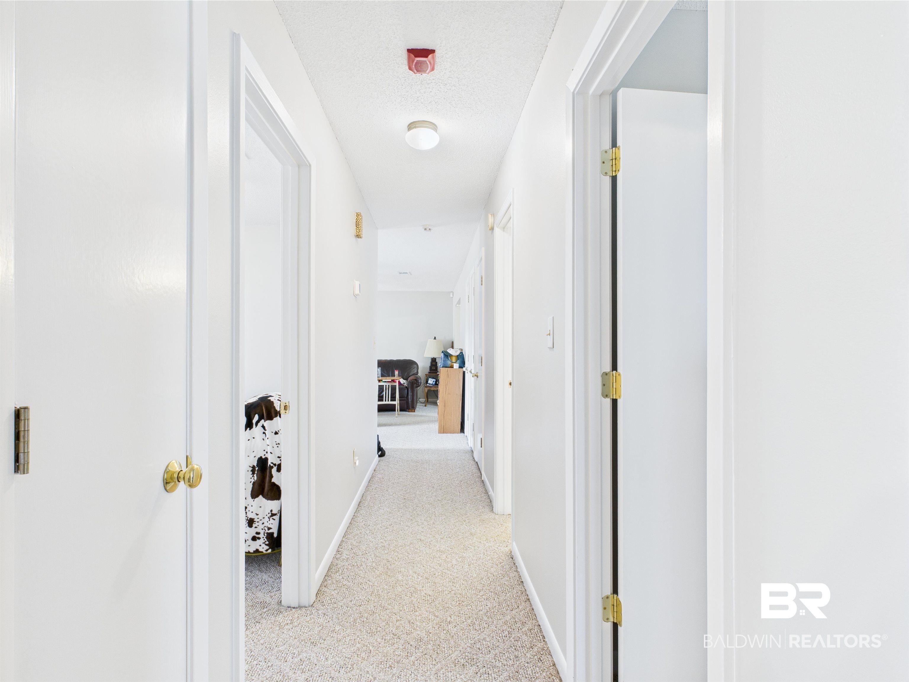 15148 Highland Circle Foley, AL 36535 - Photo 36 of 47 Corridor with light colored carpet and baseboards