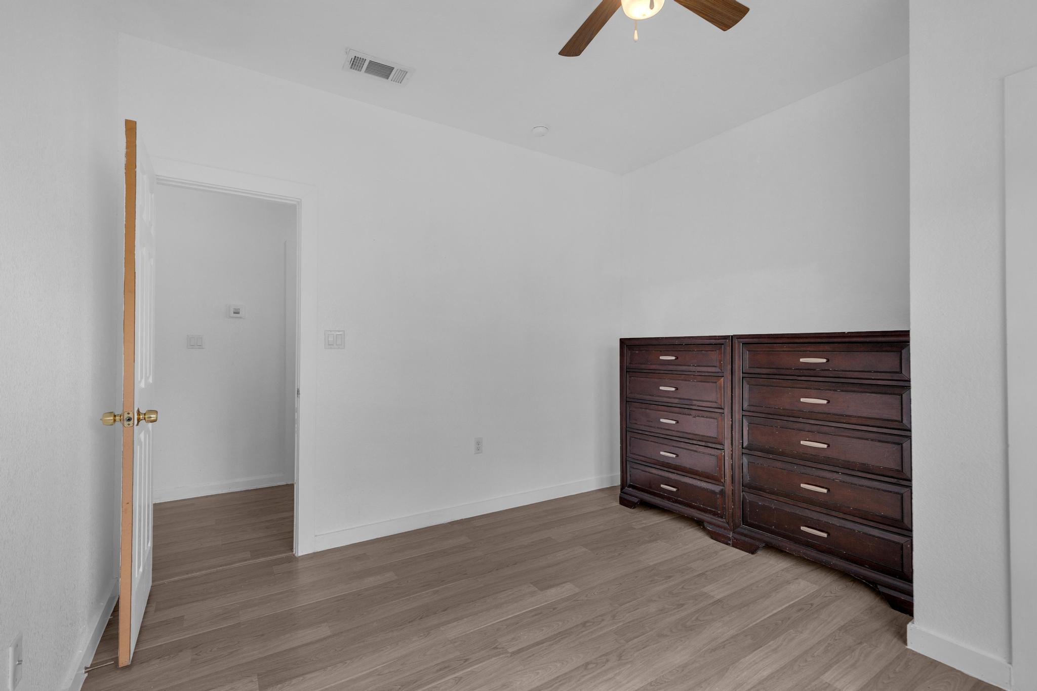 114 Crepe Myrtle Parkway Elgin, TX 78621 - Photo 14 of 40 Unit A - Unfurnished bedroom with a ceiling fan and light wood-style flooring