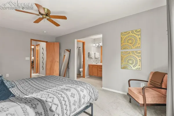 a bedroom with a bed couch and window
