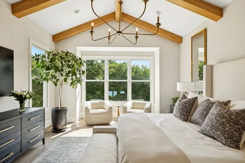 a big white house with a big yard and more windows