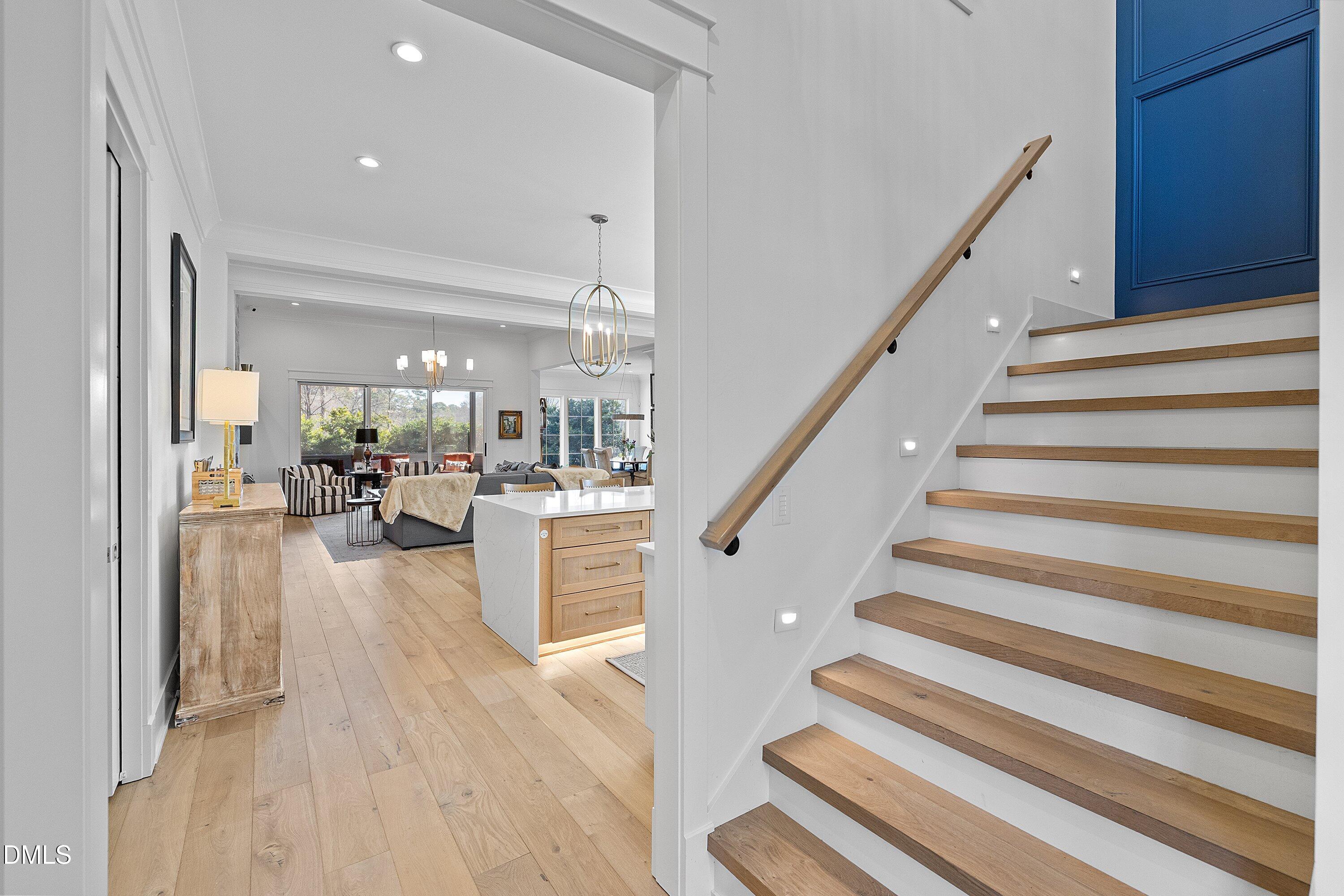 906 Brooks Avenue Raleigh, NC 27607 - Photo 11 of 64 a view of staircase and living room with wooden floor