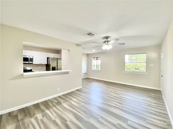 a kitchen with granite countertop a sink and stove top oven