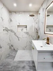 a bathroom with a sink mirror and shower