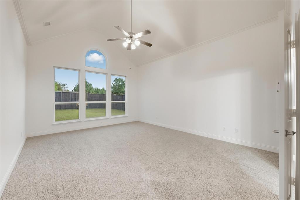 1321 Talley Lane Frisco, TX 75033 - Photo 14 of 40 Unfurnished room featuring ornamental molding, high vaulted ceiling, light carpet, and ceiling fan