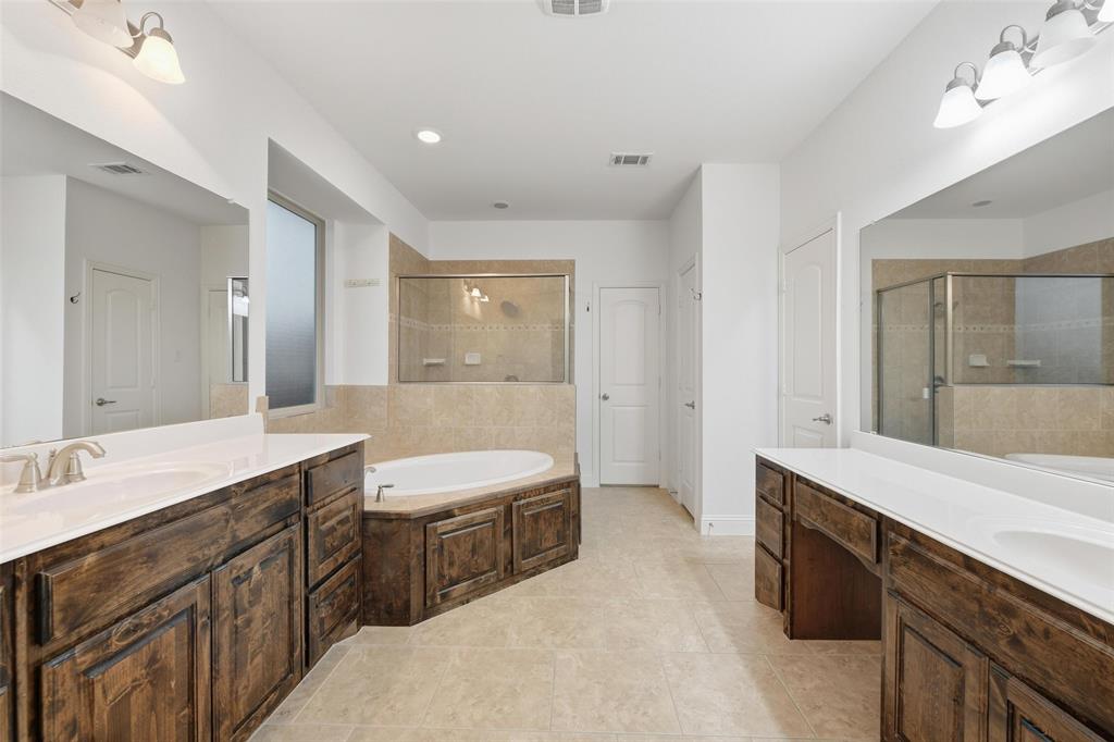 1321 Talley Lane Frisco, TX 75033 - Photo 16 of 40 Bathroom featuring a stall shower, a garden tub, two vanities, and recessed lighting
