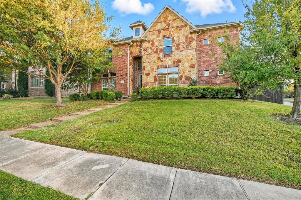 1321 Talley Lane Frisco, TX 75033 - Photo 2 of 40 Traditional-style home with stone siding, a front lawn, and brick siding