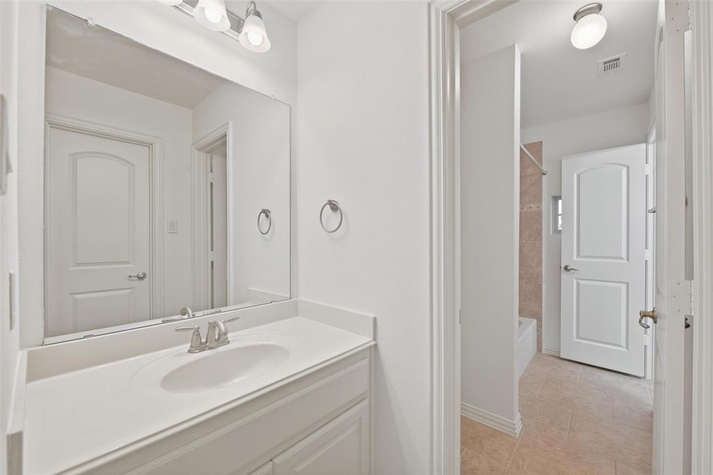1321 Talley Lane Frisco, TX 75033 - Photo 21 of 40 Full bathroom with vanity, shower / washtub combination, and light tile patterned floors