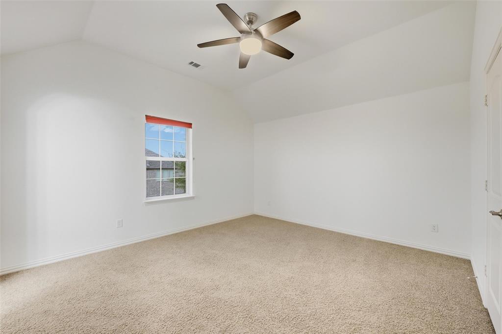 1321 Talley Lane Frisco, TX 75033 - Photo 22 of 40 Unfurnished room featuring lofted ceiling, light colored carpet, and a ceiling fan