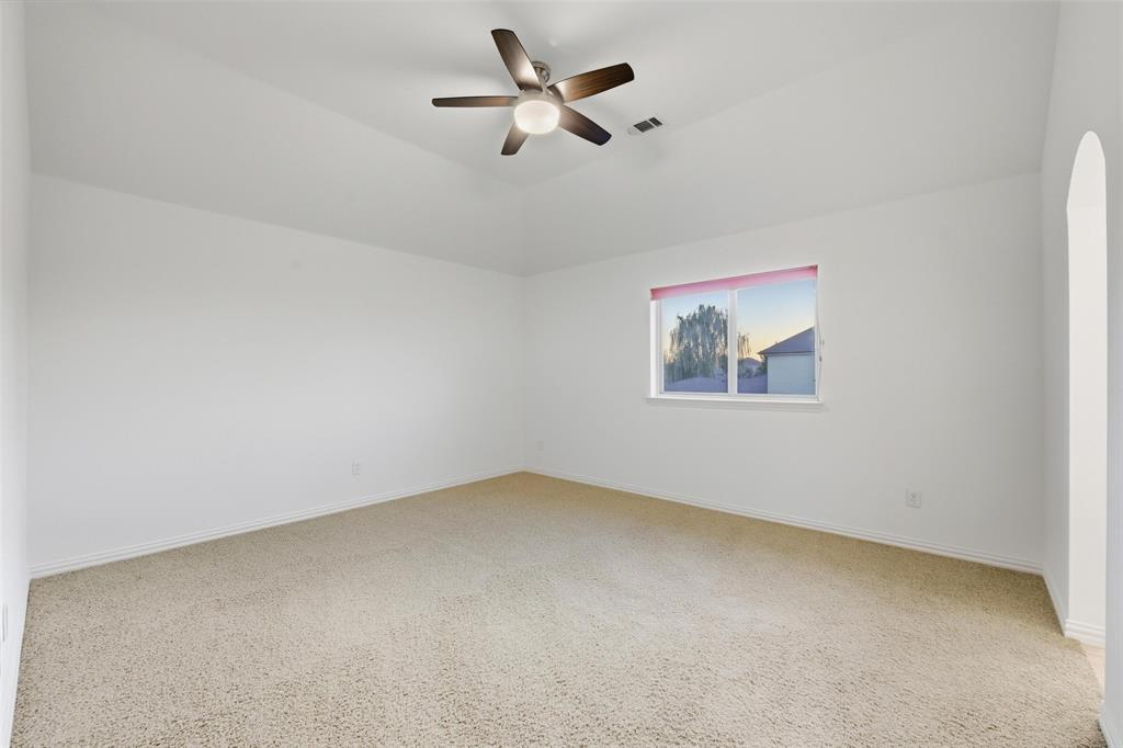 1321 Talley Lane Frisco, TX 75033 - Photo 24 of 40 Unfurnished room with light carpet, ceiling fan, and lofted ceiling