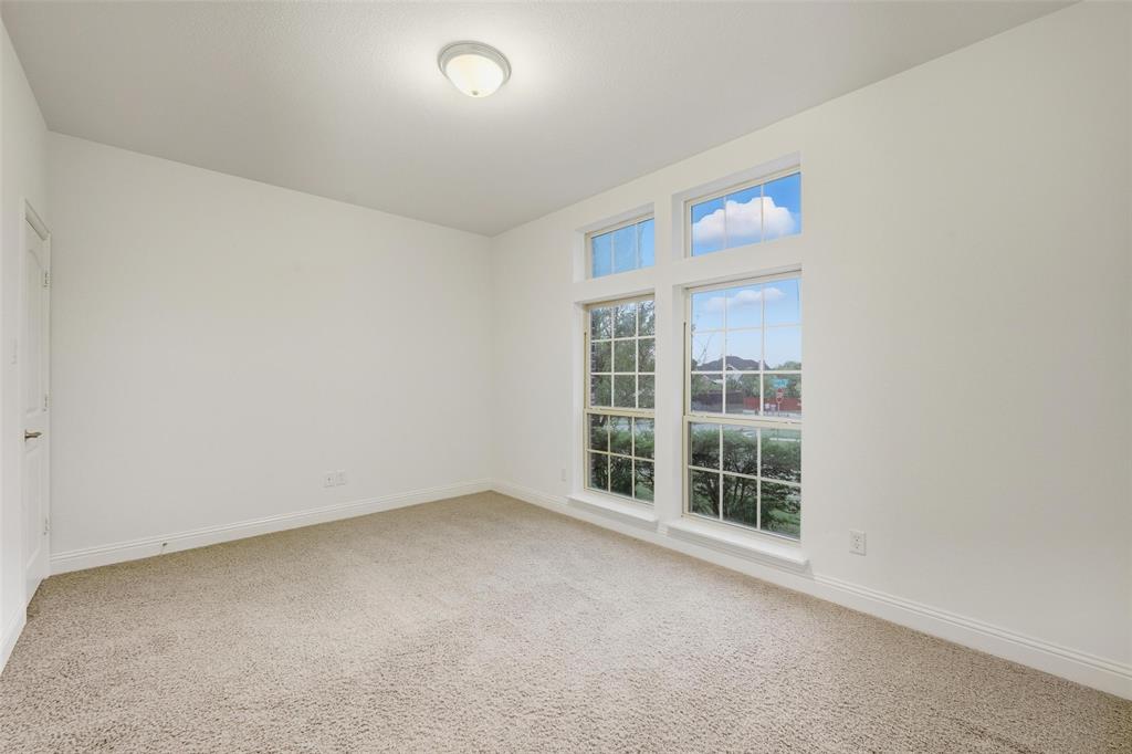 1321 Talley Lane Frisco, TX 75033 - Photo 26 of 40 Empty room with light carpet and baseboards