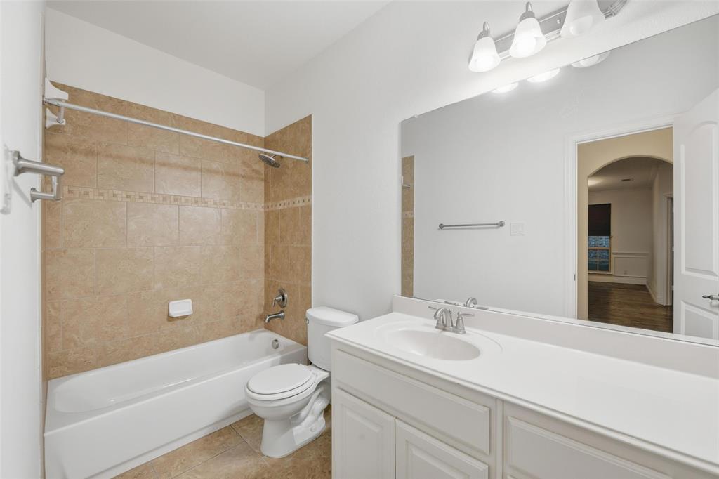 1321 Talley Lane Frisco, TX 75033 - Photo 29 of 40 Full bath with shower combination, vanity, and light tile patterned flooring