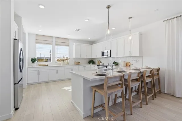 a kitchen with a white stove top oven and cabinets
