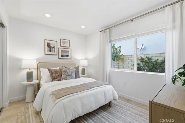 a bedroom with a bed and a large window