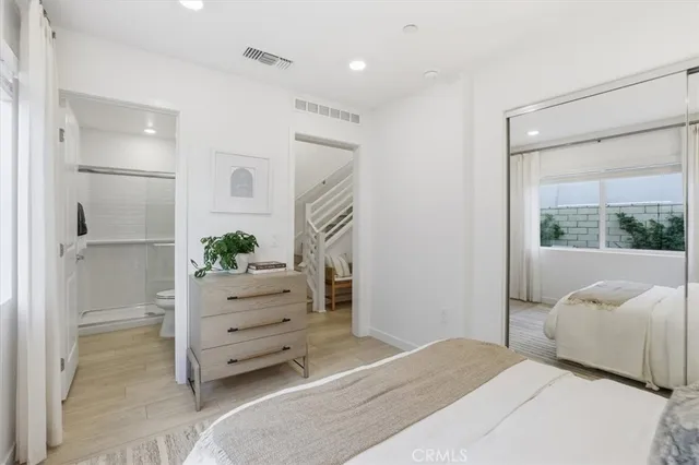 a bedroom with a bed and a dresser