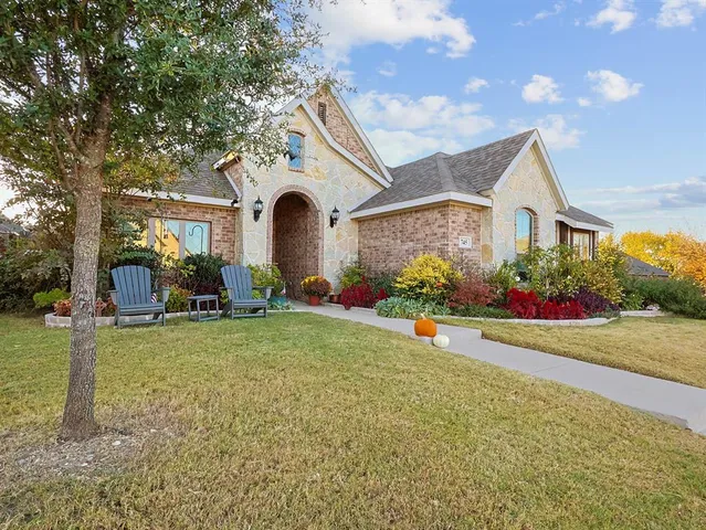 a front view of house with yard and green space