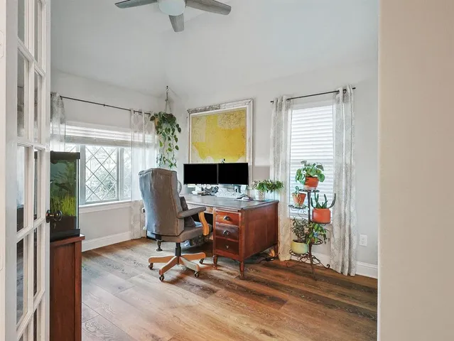 a view of a workspace with furniture and a window