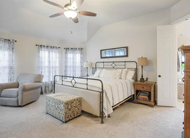 a spacious bedroom with a bed and a couch