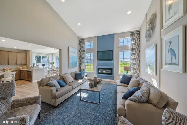 a living room with furniture fireplace and a large window