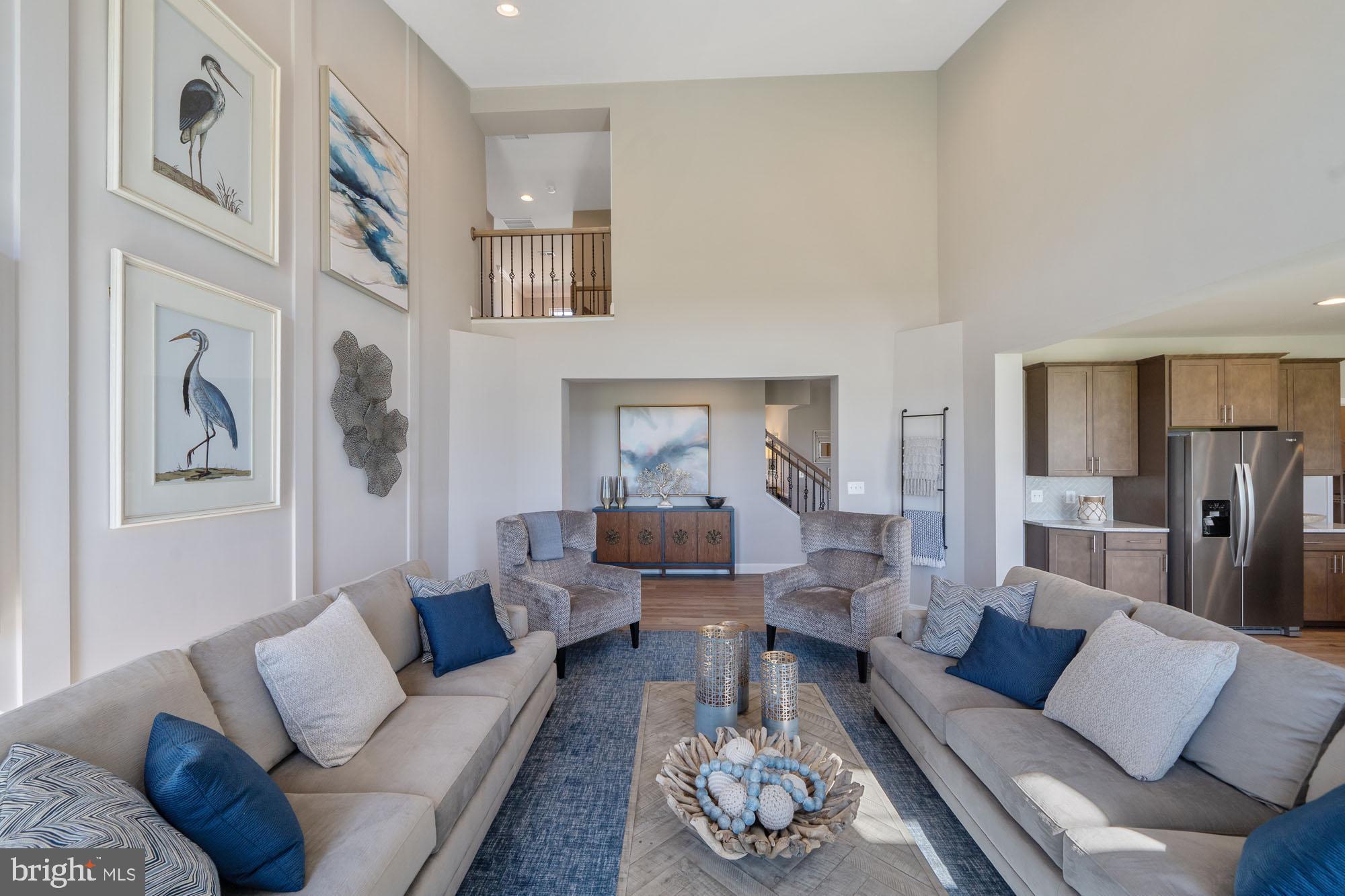 5540 Waterloo Road Columbia, MD 21045 - Photo 5 of 11 a living room with furniture couches and a dining table with wooden floor