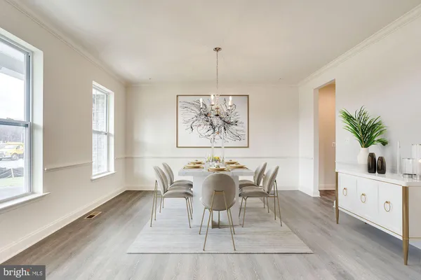 a dining room with furniture a window and wooden floor