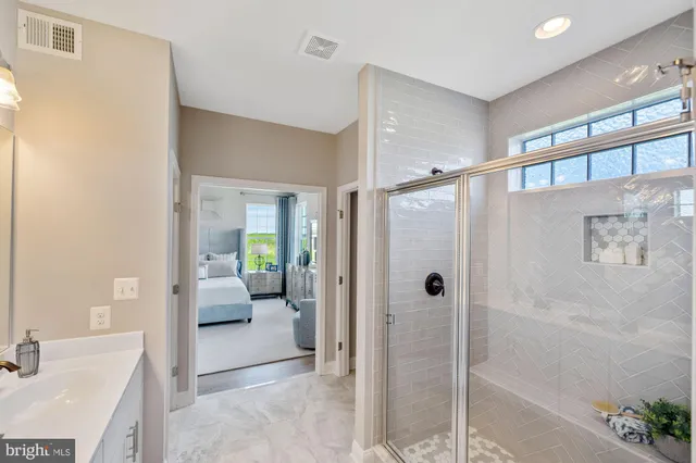 a bathroom with a tub shower and sink