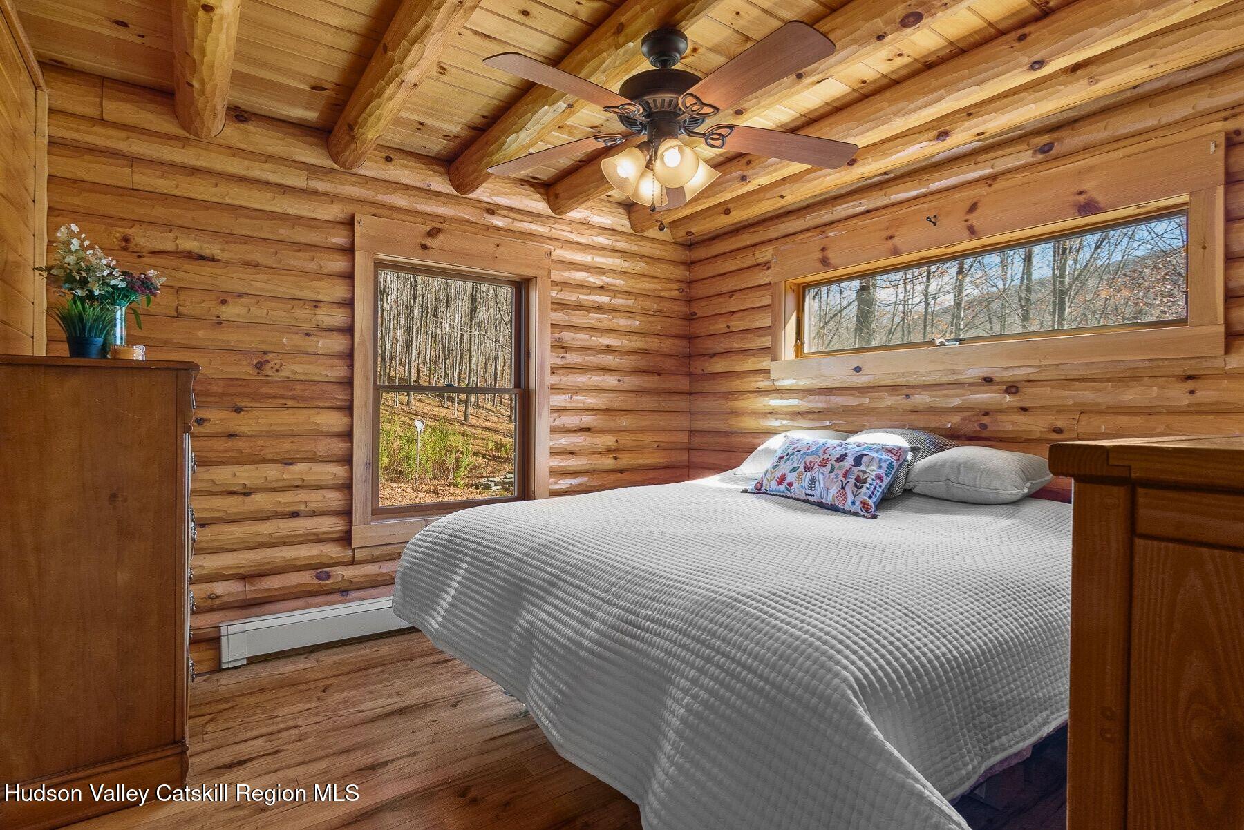 281 Turk Hollow Road Fleischmanns, NY 12430 - Photo 16 of 30 a bedroom with a bed and wooden floor