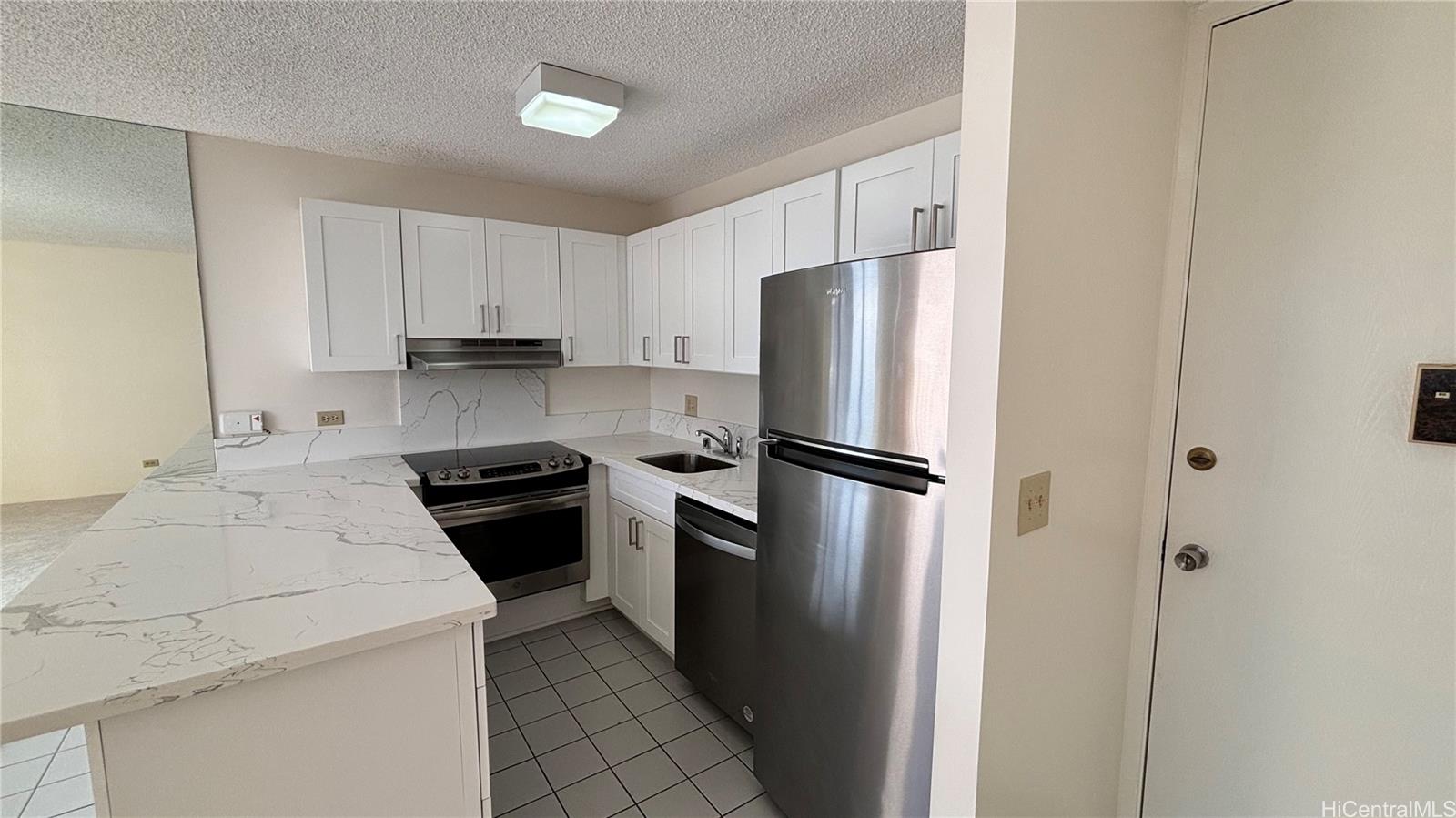 411 Hobron Lane, Unit 3208 Honolulu, HI 96815 - Photo 2 of 9 a kitchen with a refrigerator sink and stove