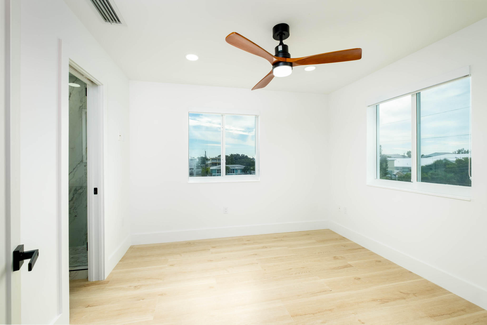 613 Portia Circle Key Largo, FL 33037 - Photo 25 of 40 a view of empty room with wooden floor and fan