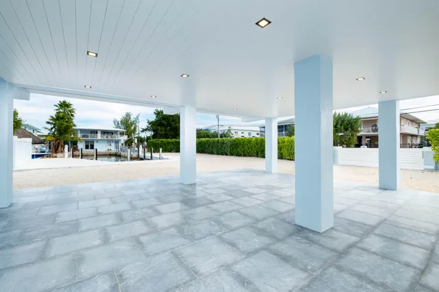 a view of house with outdoor space and tall windows
