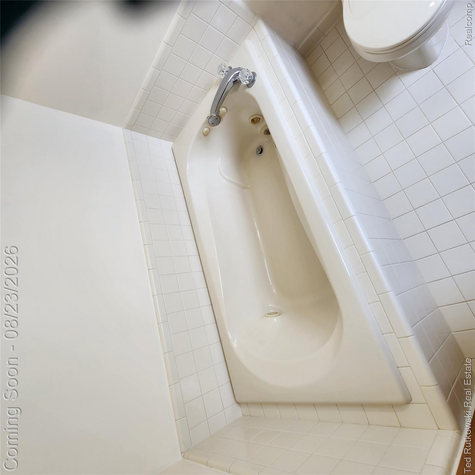 12350 Masters Road Memphis, MI 48041 - Photo 29 of 45 Built-in jetted soaking tub with chrome fixtures, surrounded by square tile