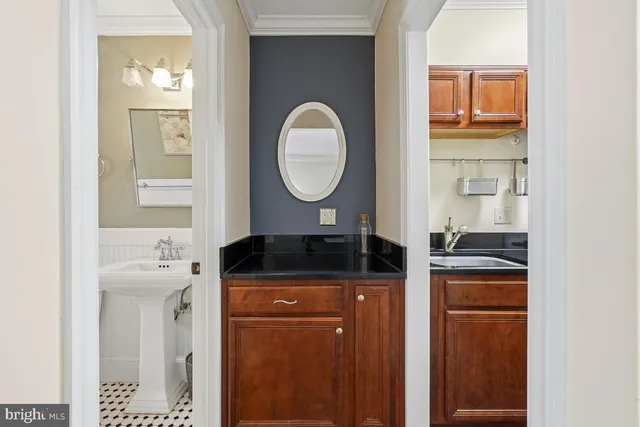 a bathroom with a granite countertop sink a toilet and a mirror
