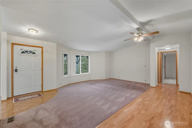 an empty room with fan and a ceiling fan